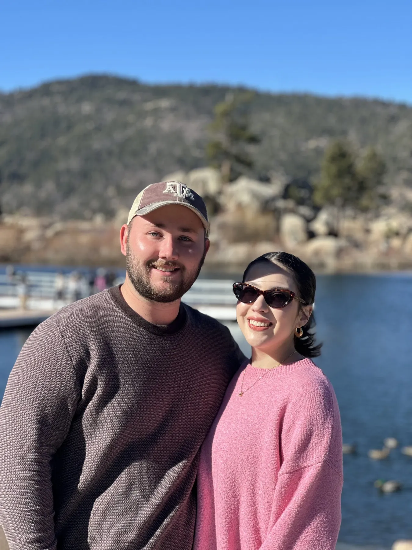 Travelers together beside a mountain lake